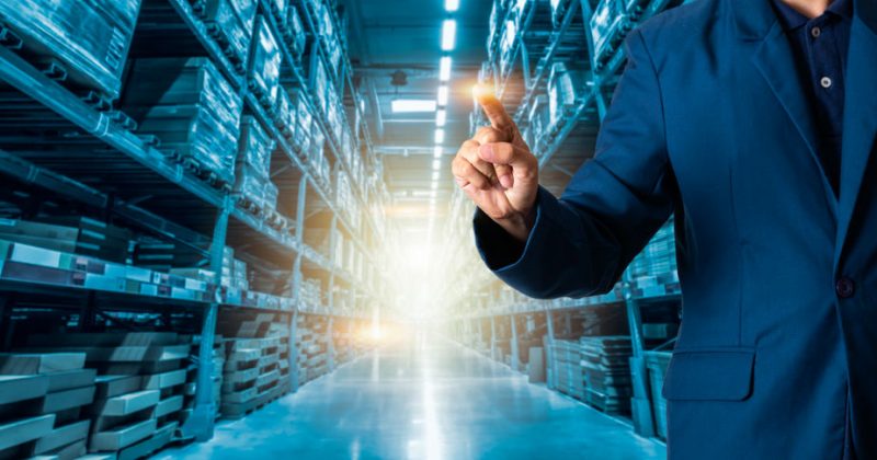 Businessman manager or CEO his fingers of logistics for workers with Modern Trade warehouse logistics